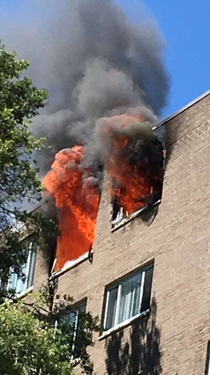 Flames erupt out a window Saturday at a Columbia Pike high-rise. (Courtesy Arlington Fire)