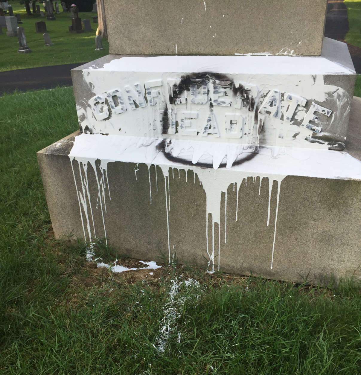 In the early hours of Thursday, someone splashed white pain on the base of the Confederate graves monument. (Courtesy Fairfax City)