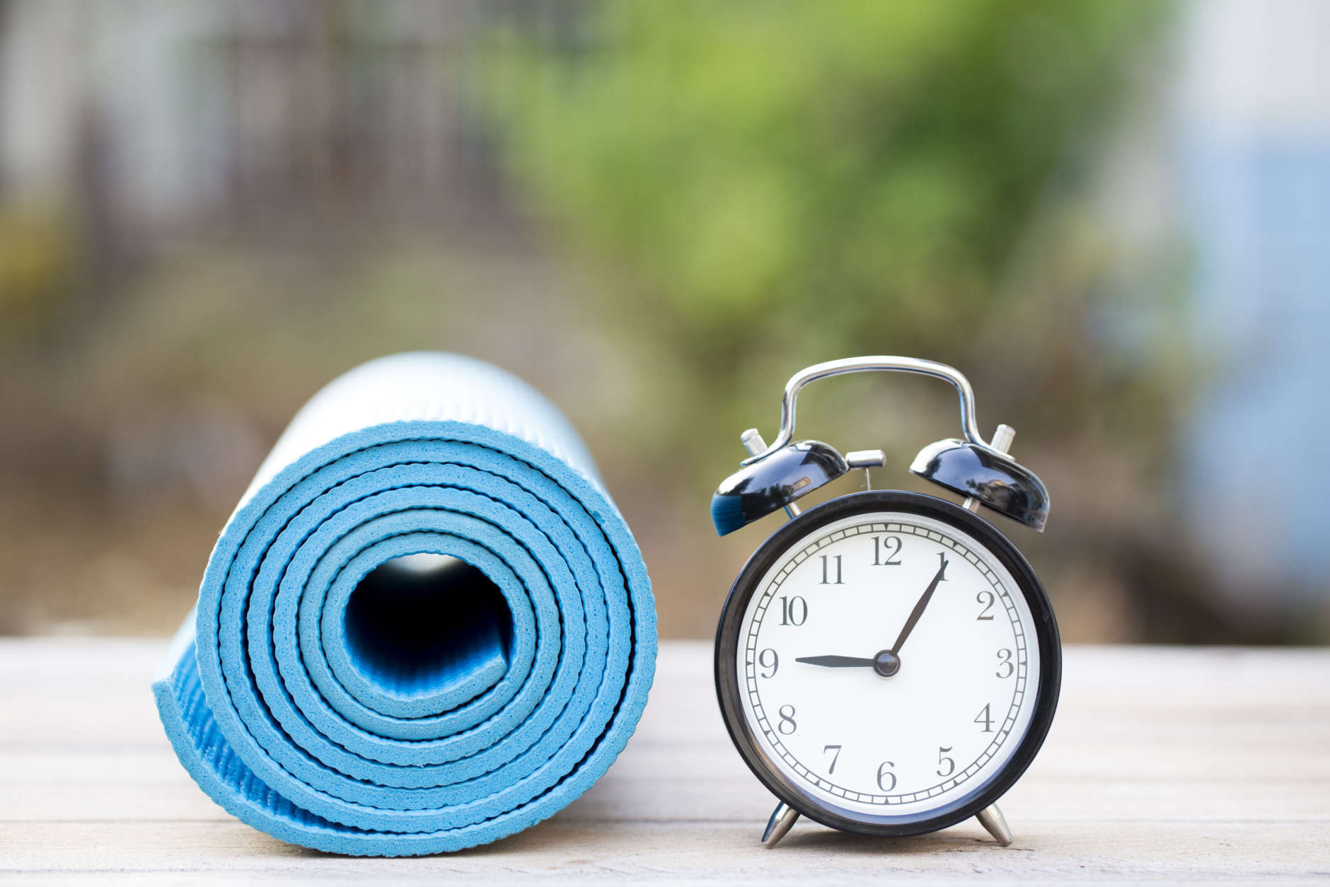 Time for exercising clock and yoga mat, outdoor