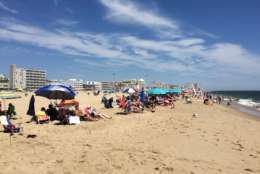 Photo shows people in bathing suits on the beach at Ocean City, Maryland