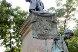 The figure holds the Scottish Rite banner. Pike is also depicted holding a book of Freemason philosphy that he wrote. The Scottish Rite paid for the statue to recognize Pike's dedication to their organization and ideals of moral and social improvement. Earlier in his life, he also supported slavery and joined the Confederate Army. The monument, erected in 1901, was the scene of a protest earlier this week and D.C. officials are now calling for its removal.  (WTOP/Amanda Iacone)