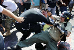 CHARLOTTESVILLE, VA - AUGUST 12:  White nationalists, neo-Nazis and members of the "alt-right" clash with counter-protesters as they enter Emancipation Park during the "Unite the Right" rally August 12, 2017 in Charlottesville, Virginia. After clashes with anti-fascist protesters and police the rally was declared an unlawful gathering and people were forced out of Emancipation Park, where a statue of Confederate General Robert E. Lee is slated to be removed.  (Photo by Chip Somodevilla/Getty Images)