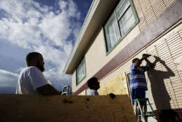 Richard Jay, right, boards up his motel with help from Dennis Seepersaue, center, and Shay Rymer ahead of Hurricane Irma in Daytona Beach, Fla., Friday, Sept. 8, 2017. Coastal residents around South Florida have been ordered to evacuate as the killer storm closes in on the peninsula for what could be a catastrophic blow this weekend. (AP Photo/David Goldman)