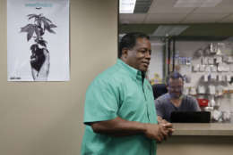 In this Sept. 8, 2017, photo, Frank Hawkins speaks with employees at the Nevada Wellness Center marijuana dispensary in Las Vegas. The former running back for the Raiders has two things that set him apart from most football players, a Super Bowl ring and a thriving pot shop just off the glittering Las Vegas Strip. (AP Photo/John Locher)