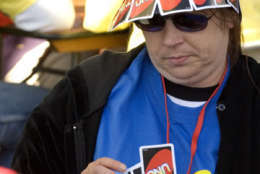 Bev Sovine shows her colors as she plays in the first round of the world's largest card tournament, as certified by an adjudicator from Guinness World Records, at Appalachian Power Park in Charleston, W.Va., Saturday, Oct. 21, 2006. The 330 participants who played UNO beat the previous record of 320 players who played the game of Quadrille in Portugal. (AP Photo/Bob Bird)