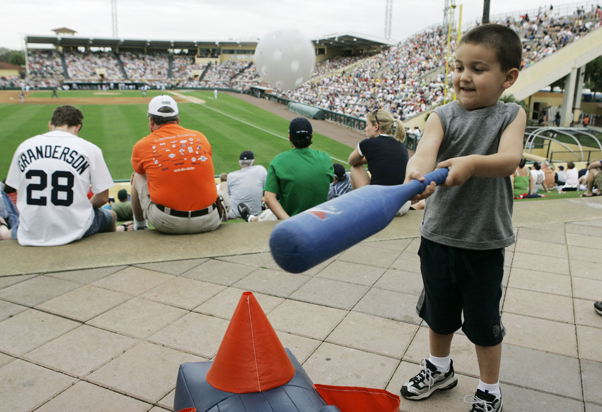 Dominic McCloy, 4, of Lakeland, Fla., hits a wiffle ball in the outfield of Joker Marchant Stadium during the Detroit Tigers-Atlanta Braves Grapefruit League spring training baseball game in Lakeland, Fla., Thursday, March 6, 2008. (AP Photo/Paul Sancya)
