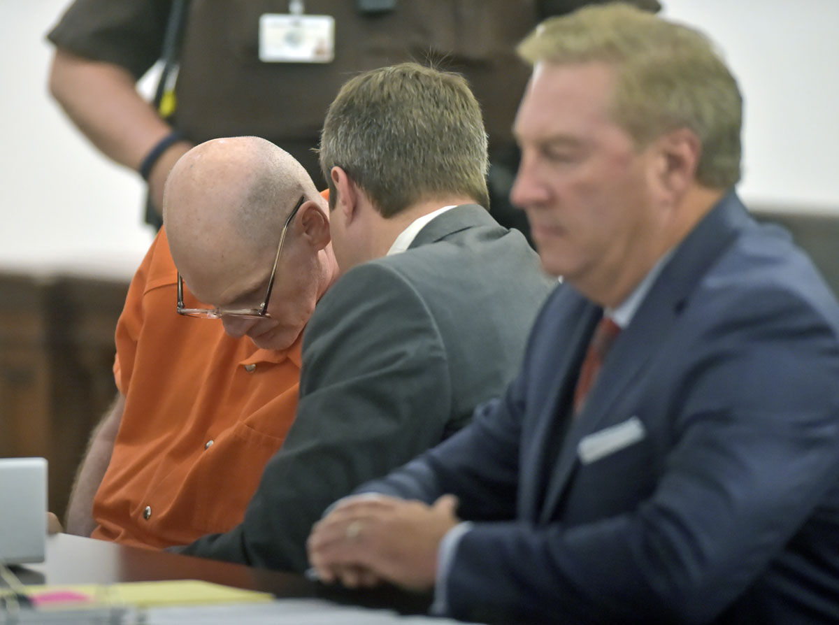 Lloyd Lee Welch Jr., left, talks with attorney Aaron Houchens, center, along with Tony anderson, right, during his plea hearing for the killings of Sheila and Katherine Lyon in 1975, in Bedford County Circuit Court in Bedford, Va., Tuesday, Sept. 12, 2017. Welch plead guilty to two counts of first degree murder and was sentenced to two consecutive 48 year sentences. (Lathan Goumas /News &amp; Daily Advance via AP, Pool)