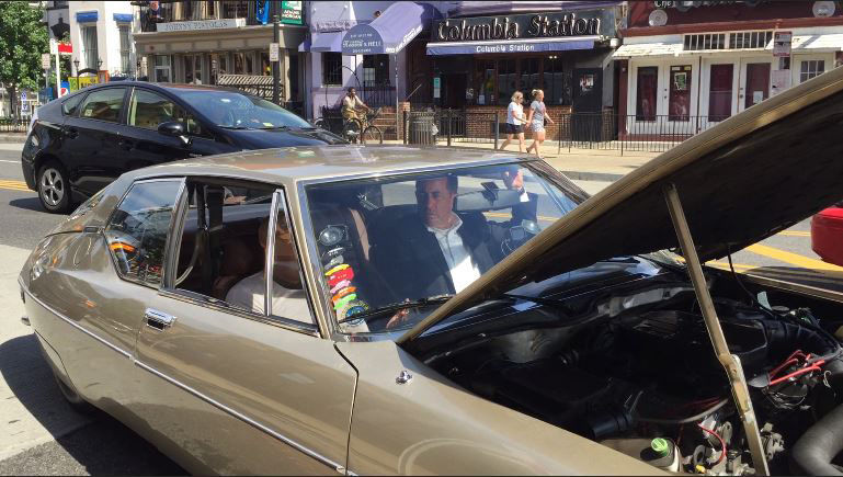 Comedians Dave Chappelle and Jerry Seinfeld sitting inside the gold Citroen coupe they were filming in. The crew ran into a glitch: The cars woudn't start. (WTOP/Kristi King)