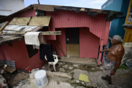 La Perla resident Ramon Marrero, 76, looks at his battered residence after the scourge of Hurricane Maria, in San Juan, Puerto Rico, Monday, Sept. 25, 2017. The island territory of more than 3 million U.S. citizens is reeling in the devastating wake of Hurricane Maria. (AP Photo/Carlos Giusti)