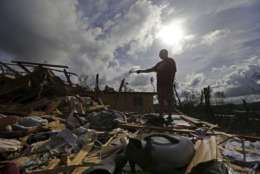 Jose Garcia Vicente holds a piece of plumbing he picked up, as he shows his destroyed home, in the aftermath of Hurricane Maria, in Aibonito, Puerto Rico, Monday, Sept. 25, 2017. The U.S. ramped up its response Monday to the humanitarian crisis in Puerto Rico while the Trump administration sought to blunt criticism that its response to Hurricane Maria has fallen short of it efforts in Texas and Florida after the recent hurricanes there. (AP Photo/Gerald Herbert)