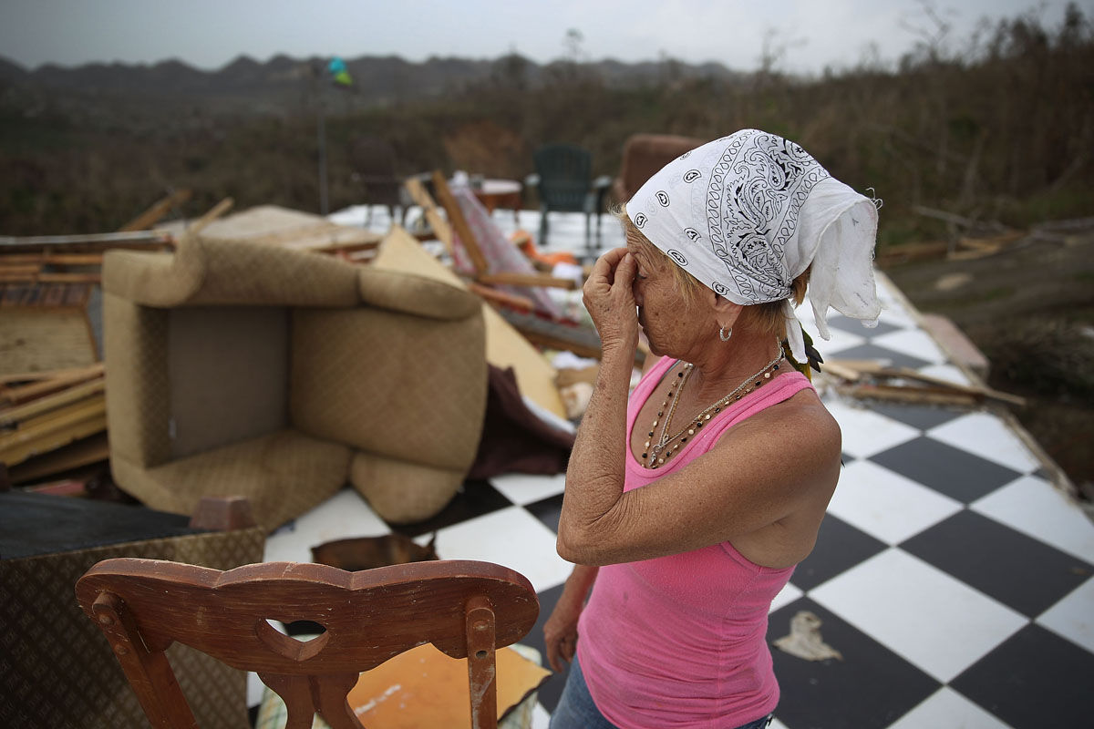 COROZAL, PUERTO RICO - SEPTEMBER 27:  Irma Maldanado stands in what is left of her home that was destroyed when Hurricane Maria passed through on September 27, 2017 in Corozal, Puerto Rico.  Puerto Rico experienced widespread damage including most of the electrical, gas and water grid as well as agriculture after Hurricane Maria, a category 4 hurricane, passed through.  (Photo by Joe Raedle/Getty Images)
