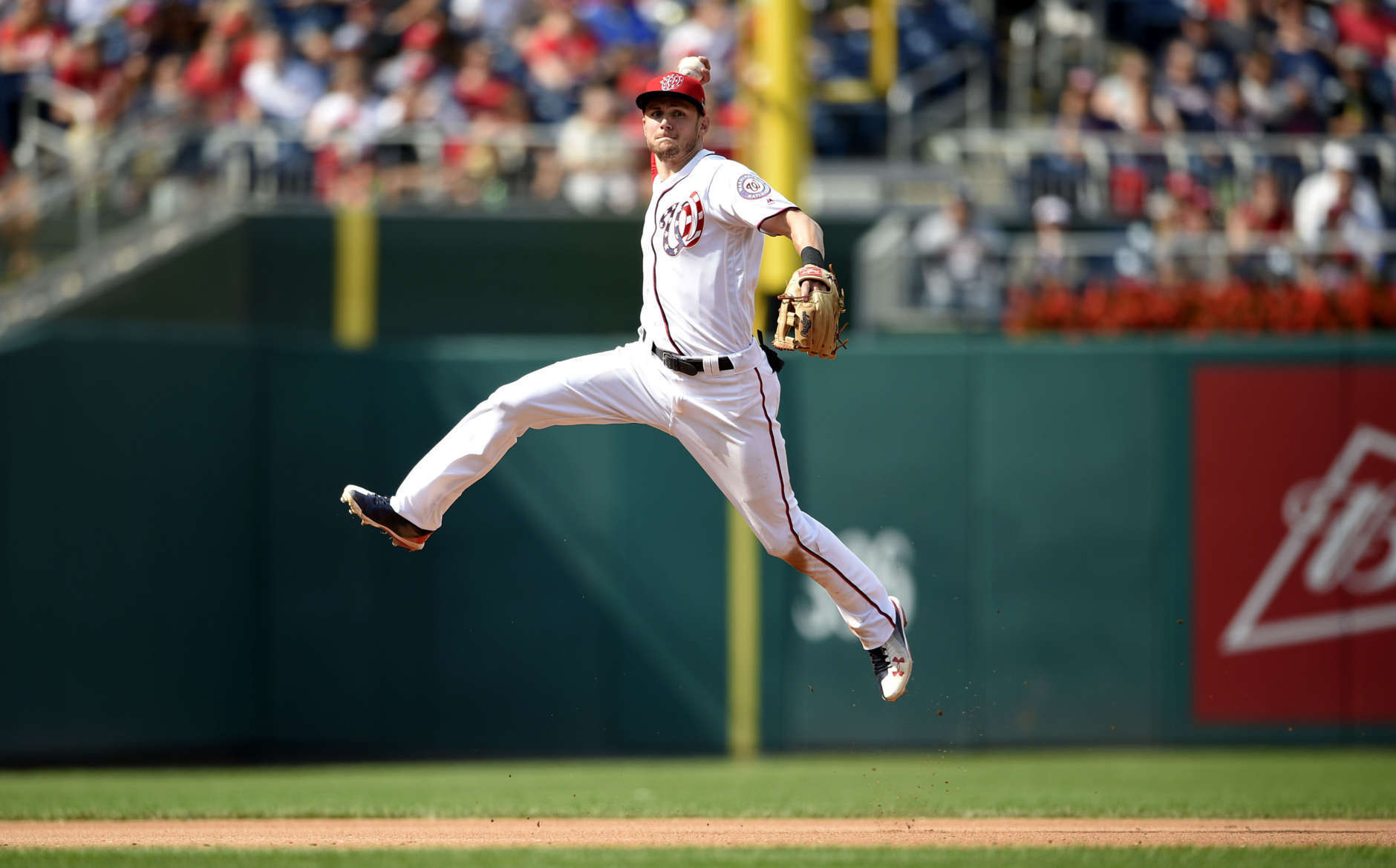 Washington Nationals shortstop Trea Turner leaps up to throw to first to get out Philadelphia Phillies Freddy Galvis during the seventh inning of a baseball game, Sunday, Sept. 10, 2017, in Washington. The Nationals won 3-2. (AP Photo/Nick Wass)