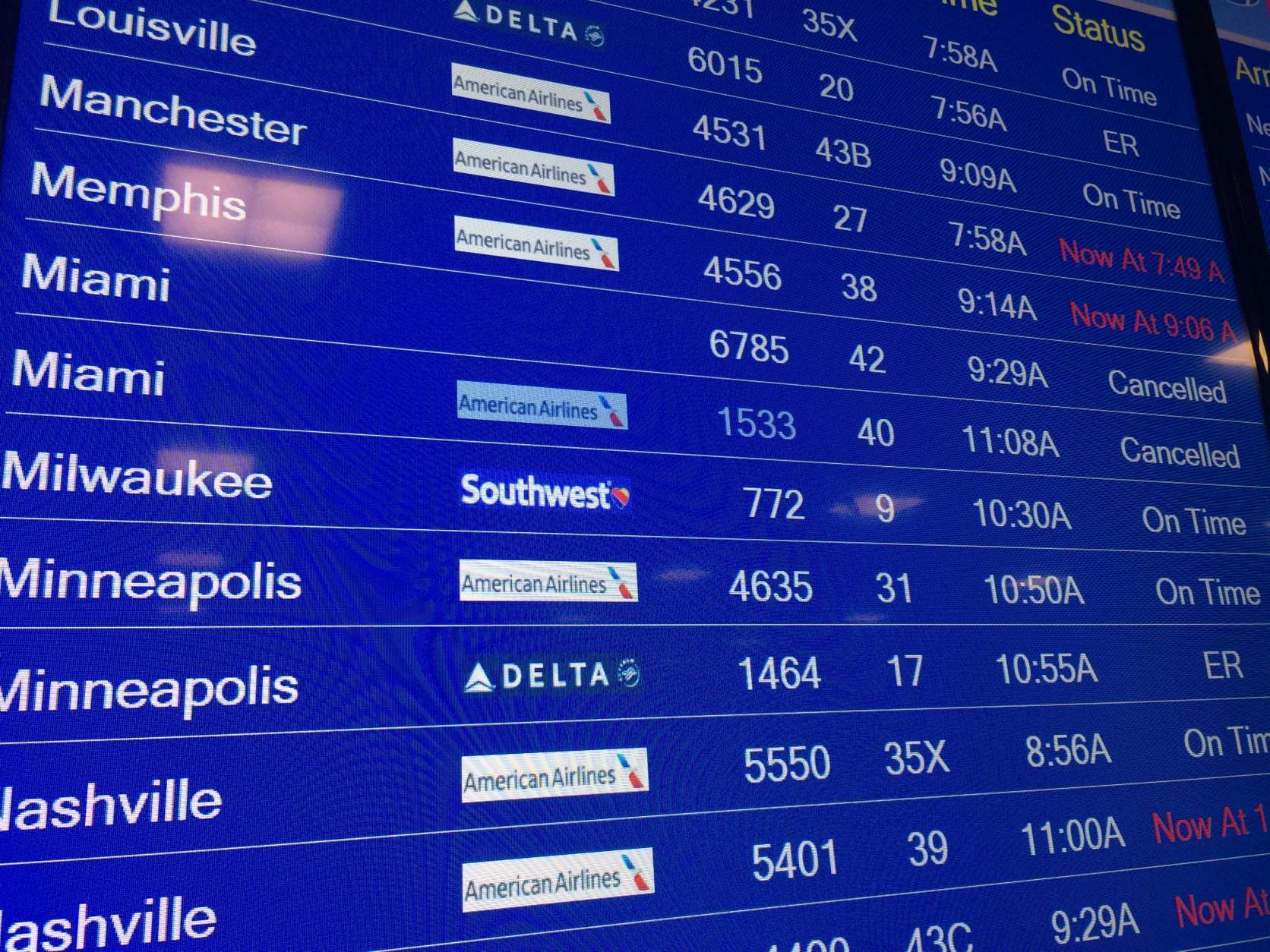 The board at Reagan National Airport Thursday shows cancellations for Miami flights. (WTOP/Nick Iannelli)