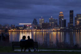 George Murff of Indianapolis sits with his friend Jasmine Riddlespriger of Clarksville, Ind., as they watch the Ohio river flow past Louisville, Ky., Friday, March 16, 2012. (AP Photo/Dave Martin)