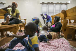 Families gather at a shelter in a local church during the evening before the arrival of Hurricane Irma in Las Terrenas, Dominican Republic, Wednesday, Sept. 6, 2017. Dominicans wait for the arrival of Hurricane Irma after it lashed Puerto Rico with heavy rain and powerful winds, leaving nearly 900,000 people without power as authorities struggled to get aid to small Caribbean islands already devastated by the historic storm. (AP Photo/Tatiana Fernandez)