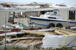 A pleasure boat stands next to a destroyed home after the passing of Hurricane Irma, in Culebra, Puerto Rico, Thursday, Sept. 7, 2017. About a million people were without power in the U.S. territory after Irma passed just to the north, lashing the island with heavy wind and rain. Nearly 50,000 also were without water. (AP Photo/Carlos Giusti)