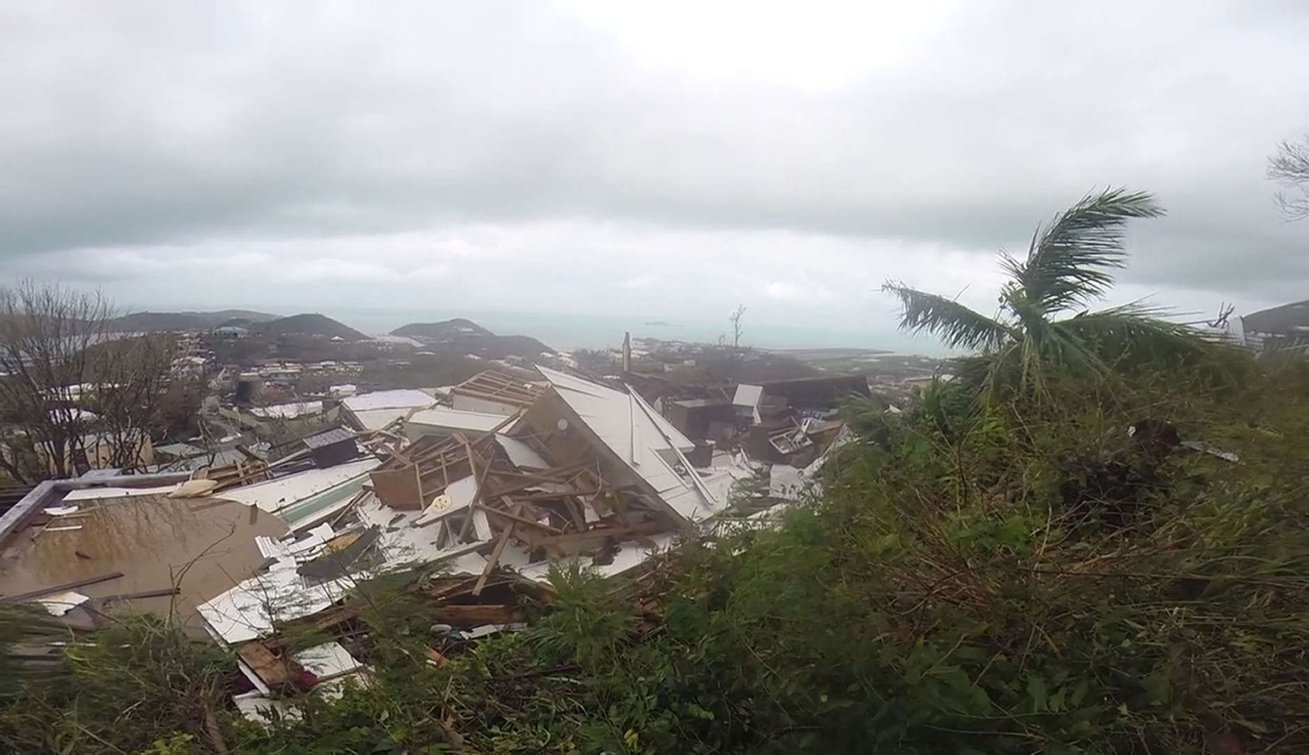 This image made from video shows several damaged houses by Hurricane Irma in St. Thomas, U.S. Virgin Islands, Thursday, Sept. 7, 2017. Hurricane Irma weakened slightly Thursday with sustained winds of 175 mph, according to the National Hurricane Center. The storm boasted 185 mph winds for a more than 24-hour period, making it the strongest storm ever recorded in the Atlantic Ocean. The storm was expected to arrive in Cuba by Friday. It could hit the Florida mainland by late Saturday, according to hurricane center models. (AP Photo/Ian Brown)