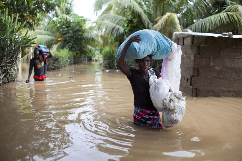 Assilia Joseph, right, and her son Wisner Jean Baptiste, carry their belongings they salvaged from their flooded home after the passing of Hurricane Irma, in Fort-Liberte, Haiti, Friday Sept. 8, 2017. Irma rolled past the Dominican Republic and Haiti and battered the Turks and Caicos Islands early Friday with waves as high as 20 feet (6 meters). ( AP Photo/Dieu Nalio Chery)
