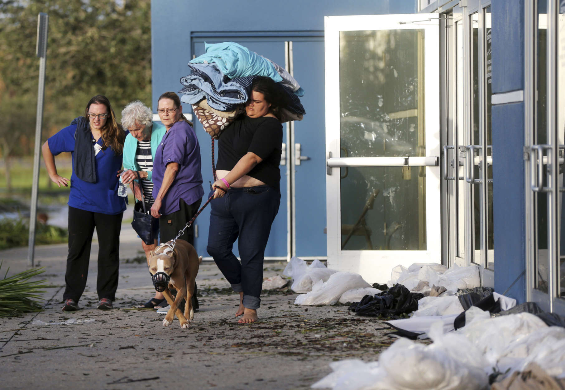 Meghan August leaves the Germain Arena, which was used as an evacuation shelter for Hurricane Irma, which passed through yesterday, in Estero, Fla., Monday, Sept. 11, 2017. (AP Photo/Gerald Herbert)