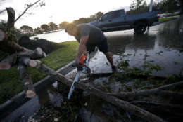 Members of the Estero Fire Department clear trees blocking roadways on their way to work, in the aftermath of Hurricane Irma, which passed through yesterday, in Estero, Fla., Monday, Sept. 11, 2017. (AP Photo/Gerald Herbert)