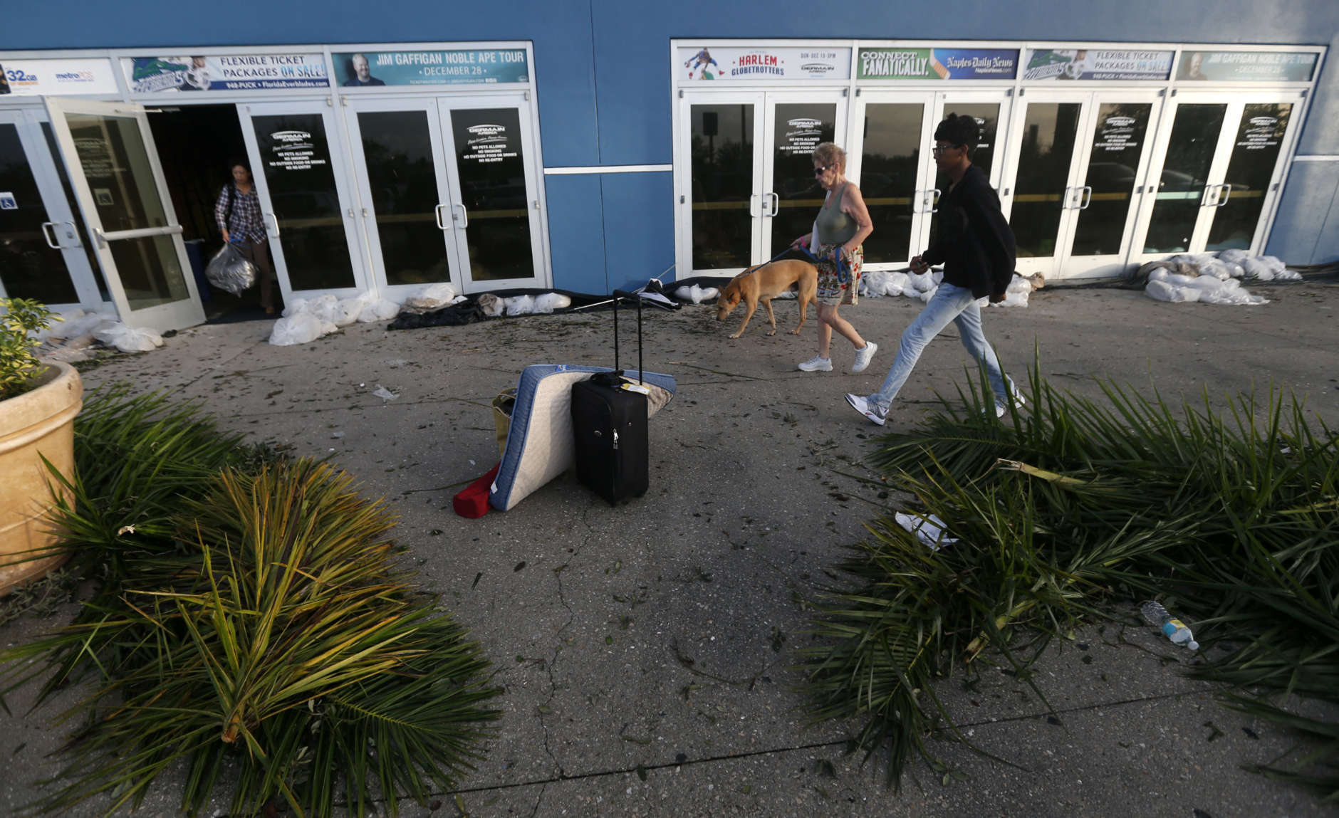 Evacuees leave the Germain Arena, which was used as an evacuation shelter for Hurricane Irma, which passed through yesterday, in Estero, Fla., Monday, Sept. 11, 2017. (AP Photo/Gerald Herbert)