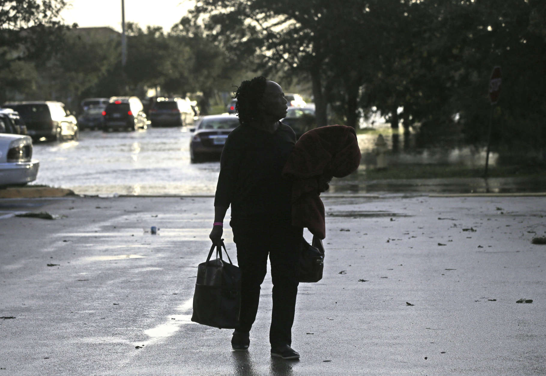 An evacuee leaves the Germain Arena, which was used as an evacuation shelter for Hurricane Irma, which passed through yesterday, in Estero, Fla., Monday, Sept. 11, 2017. (AP Photo/Gerald Herbert)