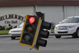 Motorists drive around a downed traffic light from winds from Hurricane Irma Monday, Sept. 11, 2017, in Mulberry, Fla. The eye of Hurricane Irma passed over the area early this morning. (AP Photo/Chris O'Meara)