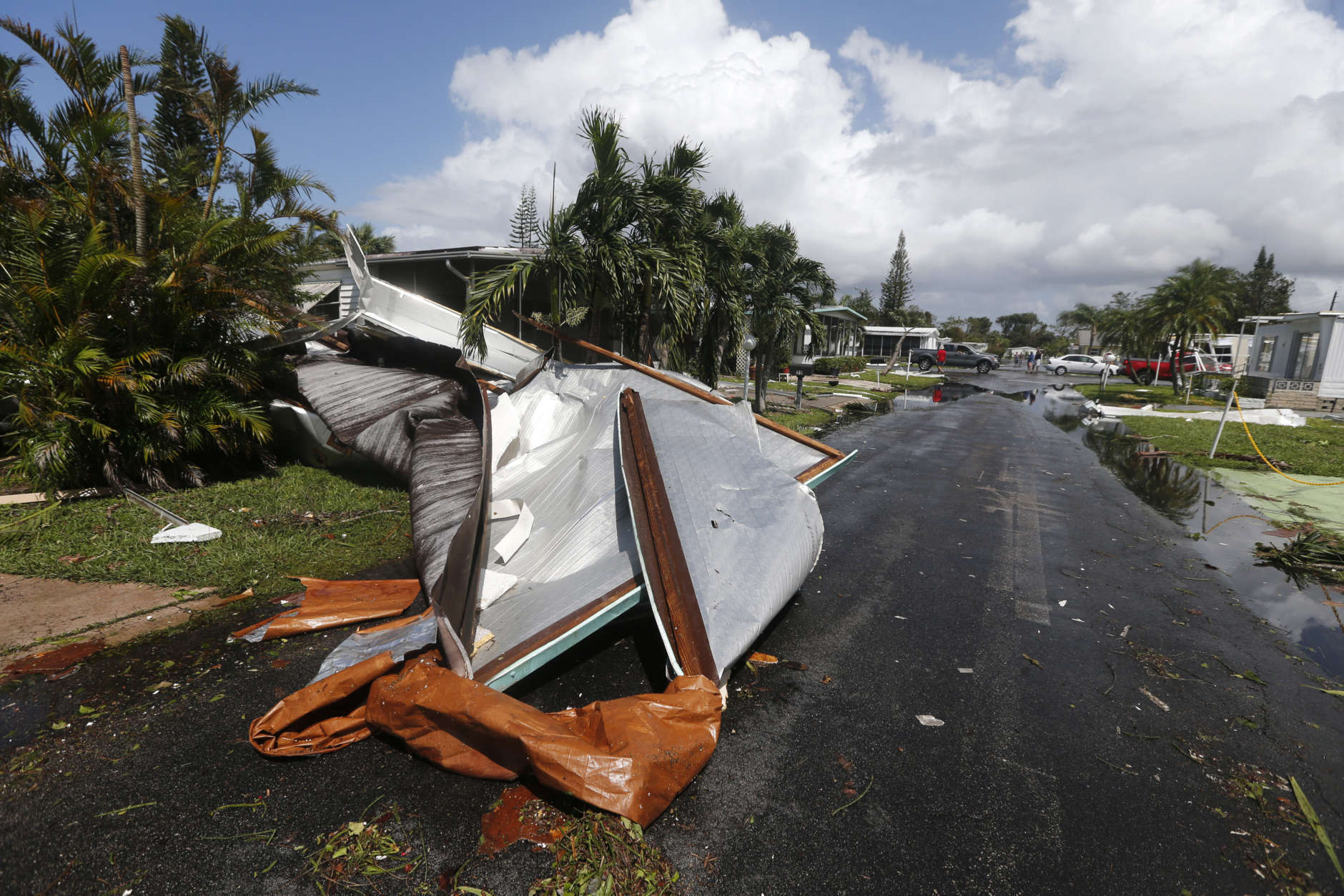 Debris from destroyed mobile homes sit in a road in the Naples Estates mobile home park which passed through yesterday, in Naples, Fla., Monday, Sept. 11, 2017. (AP Photo/Gerald Herbert)