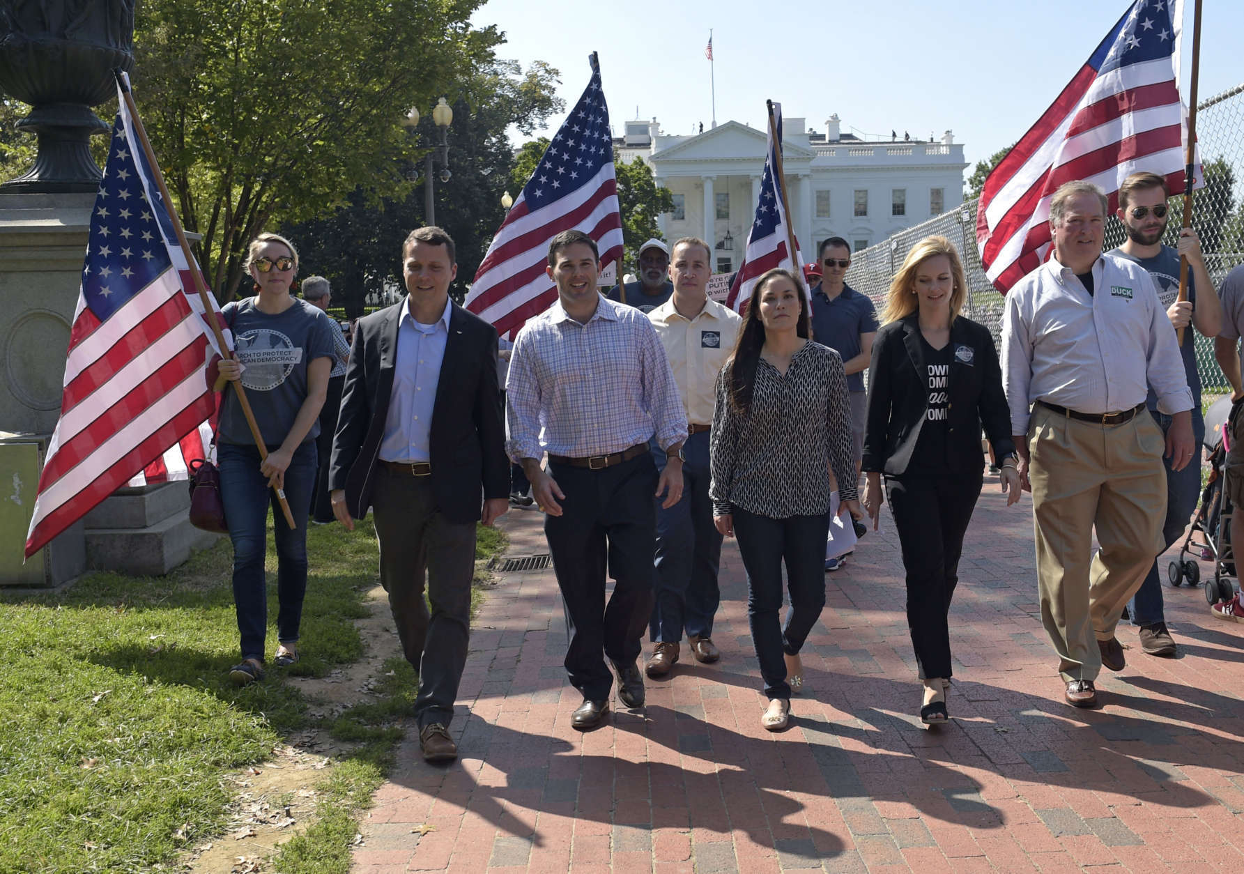 Protesters march from the White House to the Russian ambassador's residence in Washington, Saturday, Sept. 16, 2017, during a rally encouraging President Donald Trump and House Speaker Paul Ryan to defend American democracy from Russian interference. (AP Photo/Susan Walsh)