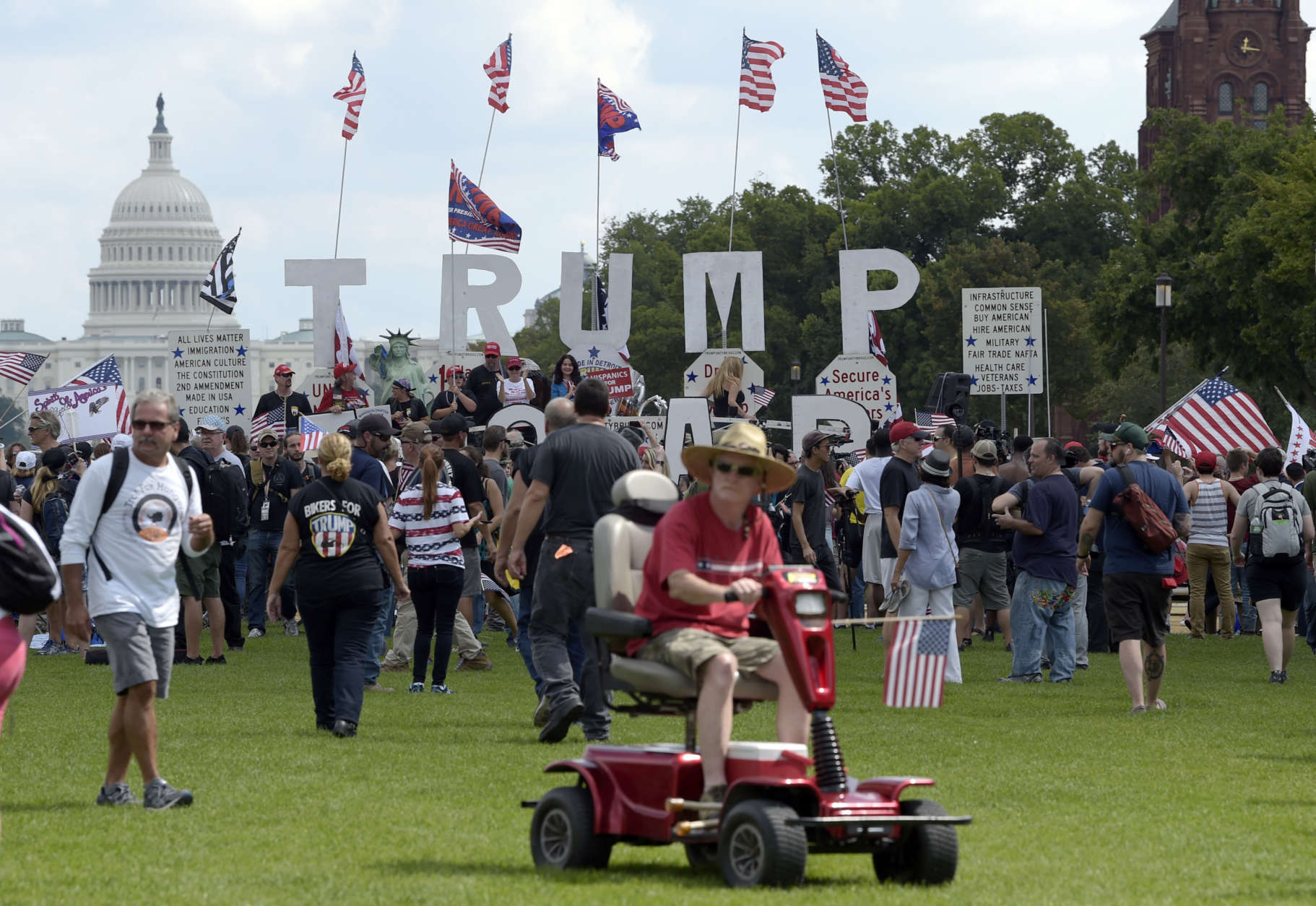 With the U.S. Capitol in the background, people gather on the National Mall in Washington, Saturday, Sept. 16, 2017, to attend a rally in support of President Donald Trump in what organizers are calling 'The Mother of All Rallies." (AP Photo/Susan Walsh)