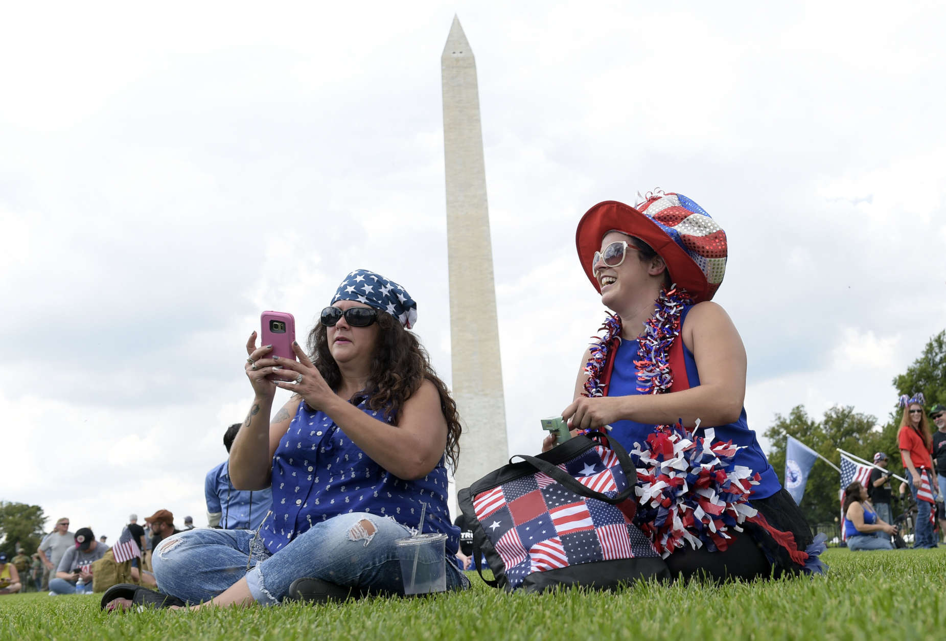 Sheri Swick, left, of Le Vale, Md., and her daughter Angel Schultz, right, of Cumberland, Md., sits on the National Mall in Washington, Saturday, Sept. 16, 2017, as they attend a rally in support of President Donald Trump in what organizers are calling 'The Mother of All Rallies." (AP Photo/Susan Walsh)