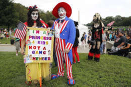 Theresa Lindsey, left, dressed as Snow White and Timothy Schlarmann, center, dressed as Uncle Sam, both from southern California, join other juggalos, as supporters of the rap group Insane Clown Posse are known, in front of the Lincoln Memorial in Washington during a rally, Saturday, Sept. 16, 2017, to protest and demand that the FBI rescind its classification of the juggalos as "loosely organized hybrid gang." (AP Photo/Pablo Martinez Monsivais)
