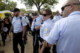 Park police officers watch demonstrators during a rally on the National Mall in Washington, Saturday, Sept. 16, 2017, in support of President Donald Trump in what organizers are calling 'The Mother of All Rallies." ( AP Photo/Jose Luis Magana)