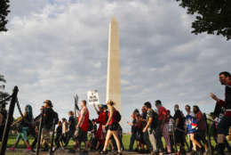 Juggalos, as supporters of the rap group Insane Clown Posse are known, march past the Washington Monument as they head towards the Lincoln Memorial in Washington during a rally, Saturday, Sept. 16, 2017. The event was held to demand that the FBI rescind its classification of the juggalos as a "loosely organized hybrid gang." (AP Photo/Pablo Martinez Monsivais)