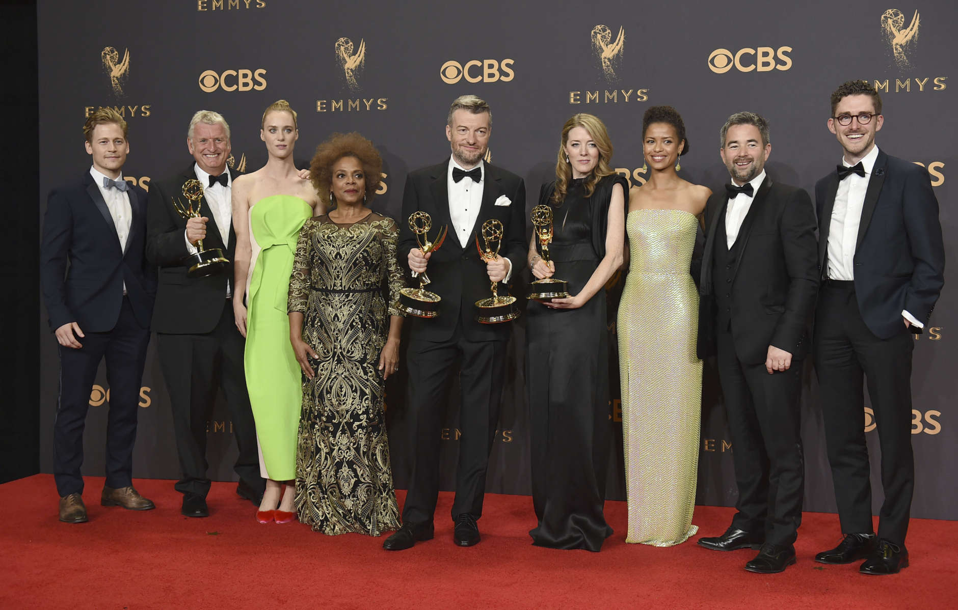 The cast and crew of "Black Mirror: San Junipero" pose in the press room with their awards for for outstanding television movie at the 69th Primetime Emmy Awards on Sunday, Sept. 17, 2017, at the Microsoft Theater in Los Angeles. (Photo by Jordan Strauss/Invision/AP)