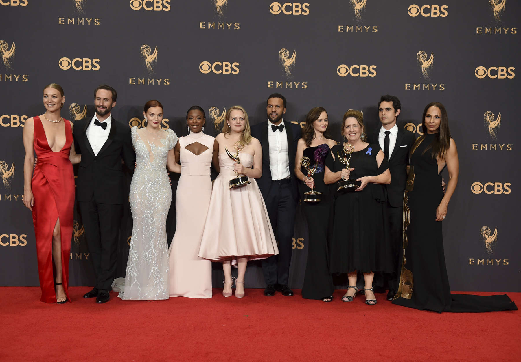Yvonne Strahovski, from left, Joesph Fiennes, Madeline Brewer, Samira Wiley, Elisabeth Moss, O-T Fagbenle, Alexis Bledel, Ann Dowd, Max Minghella, and Amanda Brugel pose in the press room with their award for for outstanding drama series for "The Handmaid's Tale" at the 69th Primetime Emmy Awards on Sunday, Sept. 17, 2017, at the Microsoft Theater in Los Angeles. (Photo by Jordan Strauss/Invision/AP)