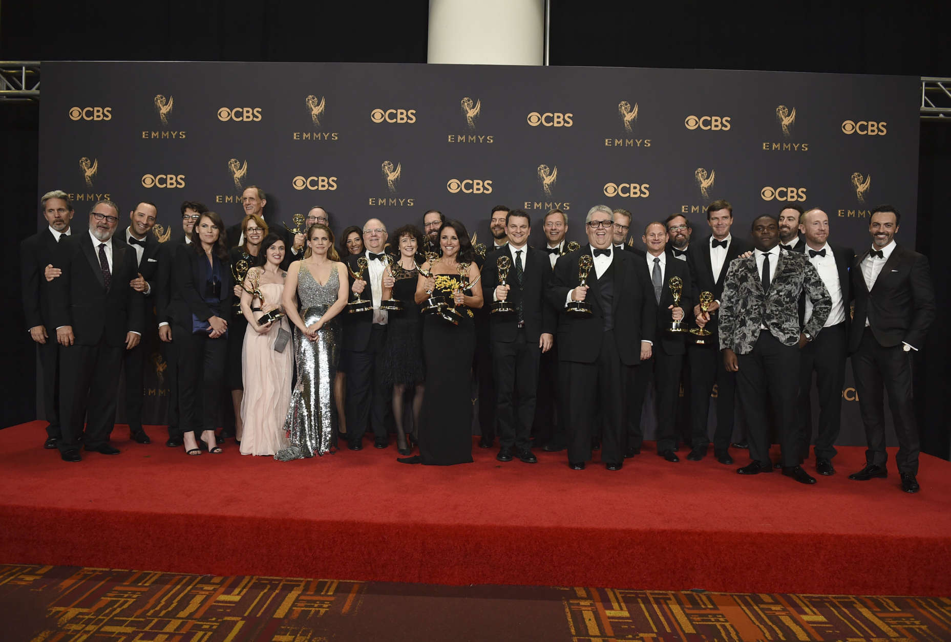 The cast and crew of "Veep" pose in the press room with the award for outstanding comedy series at the 69th Primetime Emmy Awards on Sunday, Sept. 17, 2017, at the Microsoft Theater in Los Angeles. (Photo by Jordan Strauss/Invision/AP)