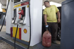 Luis Fonseca fills a container with gasoline at a gas station one day before the forecasted arrival of Hurricane Maria in San Juan, Puerto Rico, Tuesday, Sept. 19, 2017. Authorities in the U.S. territory of Puerto Rico, which faces the possibility of a direct hit, warned that people in wooden or flimsy homes should find safe shelter before the storm’s expected arrival there on Wednesday. (AP Photo/Carlos Giusti)