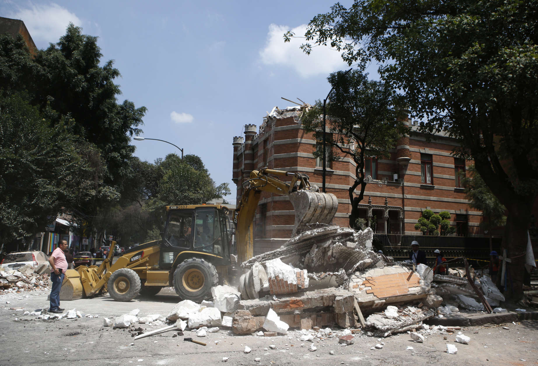 A bulldozer removes debris from a partially collapsed building after an earthquake in Mexico City, Tuesday, Sept. 19, 2017. A powerful earthquake jolted central Mexico on Tuesday, causing buildings to sway sickeningly in the capital on the anniversary of a 1985 quake that did major damage. (AP Photo/Rebecca Blackwell)
