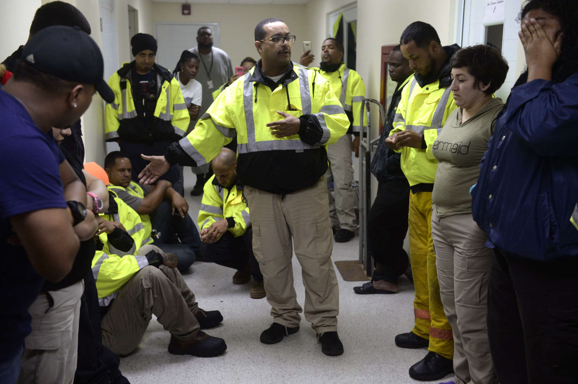 Team leader Joey Rivera gives a speech while feelings of frustration surround the members of the rescue team from the municipality of Humacao, desperate to go out to attend several calls for help from citizens in need of assistance during the impact of Maria, a Category 5 hurricane that started to hit the eastern region of the island, in Humacao, Puerto Rico, Tuesday, Sept. 20, 2017.  Puerto Rico faced Wednesday what officials said could be the strongest hurricane to ever hit the U.S. territory as they warned it would decimate the power company's crumbling infrastructure and force the government to rebuild dozens of communities.(AP Photo/Carlos Giusti)