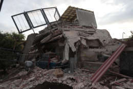 A building demolished by a 7.1 earthquake sits in pile of rubble, in Jojutla, Morelos state, Mexico, Wednesday, Sept. 20, 2017. Police, firefighters and ordinary Mexicans are digging frantically through the rubble of collapsed schools, homes and apartment buildings, looking for survivors of Mexico's deadliest earthquake in decades as the number of confirmed fatalities climbed to 248. (AP Photo/Eduardo Verdugo)