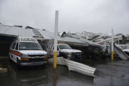 Rescue vehicles from the Emergency Management Agency stand trapped under an awning during the impact of Hurricane Maria, which hit the eastern region of the island, in Humacao, Puerto Rico, Wednesday, Sept. 20, 2017. The U.S. National Hurricane Center says Maria has lost its major hurricane status, after raking Puerto Rico. But forecasters say some strengthening is in the forecast and Maria could again become a major hurricane by Thursday. (AP Photo/Carlos Giusti)