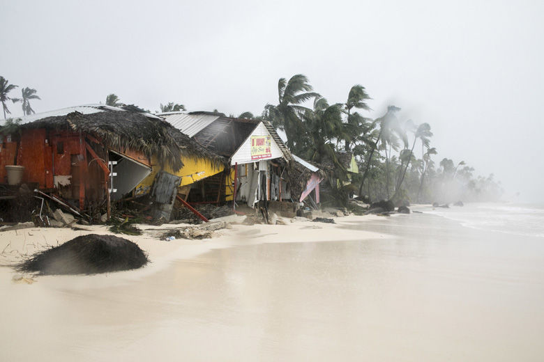 A gift shop damaged in the crossing of Hurricane Maria is shown on Cofrecito Beach, Bavaro, Dominican Republic, Thursday, Sept. 21, 2017.  Rain from the storm will continue in the Dominican Republic for the next two days according to meteorologists. (AP Photo/Tatiana Fernandez)