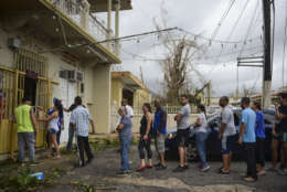 People wait in line to buy bread at Ortiz bakery after the passing of Hurricane Maria, in Yabucoa, Puerto Rico, Thursday, September 21, 2017. As of Thursday evening, Maria was moving off the northern coast of the Dominican Republic with winds of 120 mph (195 kph). The storm was expected to approach the Turks and Caicos Islands and the Bahamas late Thursday and early Friday. (AP Photo/Carlos Giusti)