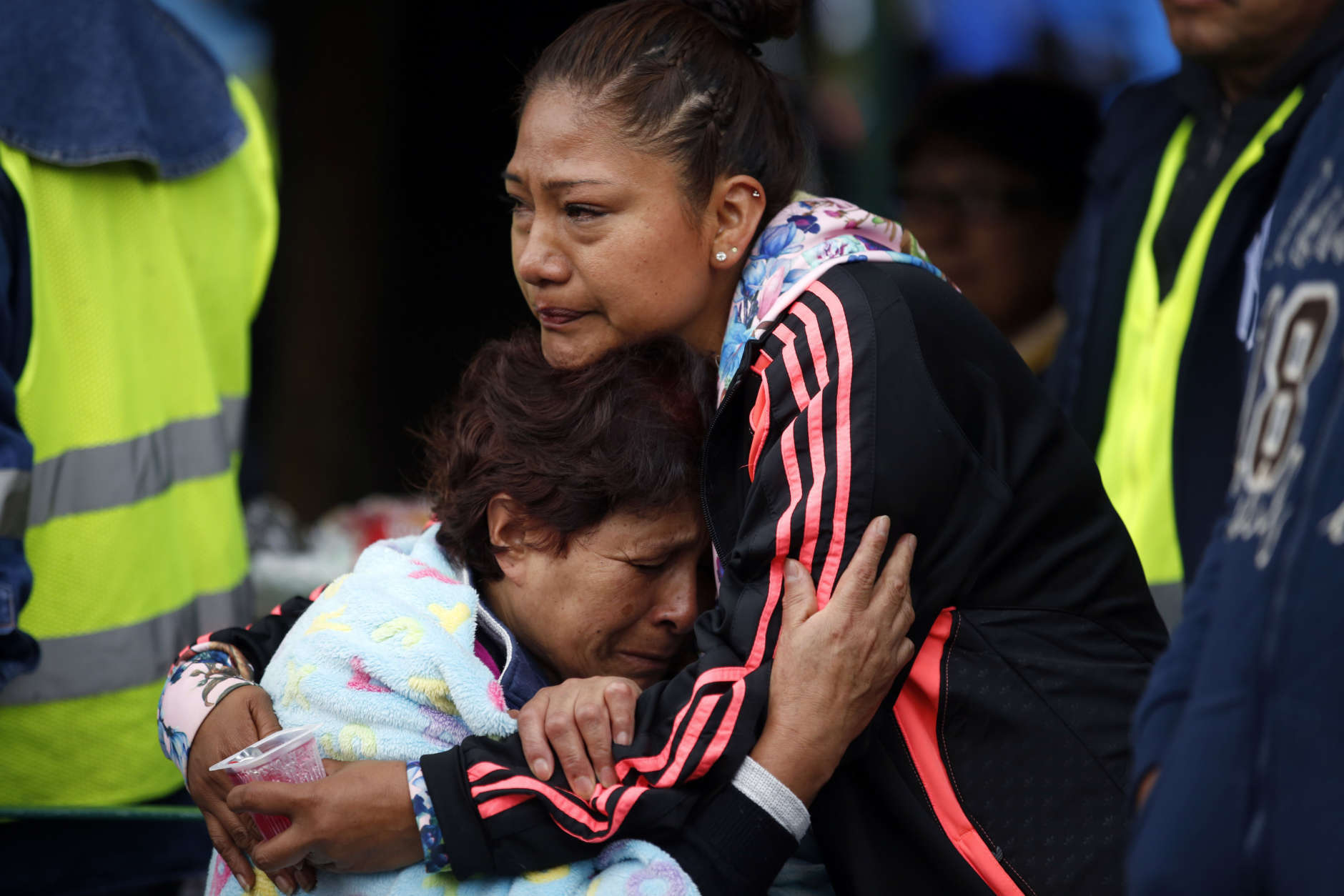 Family members embrace as they wait for news of their relatives outside a quake-collapsed seven-story building in Mexico City's Roma Norte neighborhood, Friday, Sept. 22, 2017. Mexican officials are promising to keep up the search for survivors as rescue operations stretch into a fourth day following Tuesday's major earthquake that devastated Mexico City and nearby states. (AP Photo/Rebecca Blackwell)