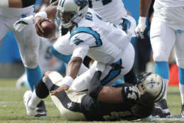 Carolina Panthers' Cam Newton (1) is sacked by New Orleans Saints' Hau'oli Kikaha (44) in the second half of an NFL football game in Charlotte, N.C., Sunday, Sept. 24, 2017. (AP Photo/Bob Leverone)