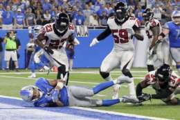 Detroit Lions wide receiver Golden Tate, bottom left, falls into the end zone for a 1-yard touchdown reception during the second half of an NFL football game against the Atlanta Falcons, Sunday, Sept. 24, 2017, in Detroit. The replay official reviewed the score ruling and the play was reversed. (AP Photo/Duane Burleson)