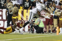 Oakland Raiders tight end Jared Cook (87) gets the ball into the end zone for a touchdown under pressure from Washington Redskins strong safety Deshazor Everett (22) during the second half of an NFL football game in Landover, Md., Sunday, Sept. 24, 2017. (AP Photo/Pablo Martinez Monsivais)