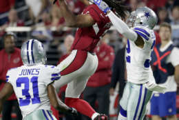 Arizona Cardinals wide receiver Larry Fitzgerald (11) makes the catch as Dallas Cowboys free safety Byron Jones (31) and cornerback Orlando Scandrick (32) defend during the second half of an NFL football game, Monday, Sept. 25, 2017, in Glendale, Ariz. (AP Photo/Rick Scuteri)
