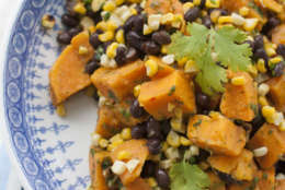 This May 5, 2014, photo shows sweet potato, grilled corn and black bean salad with spicy cilantro dressing in Concord, N.H. This recipe swaps sweet potatoes for the more traditional white potatoes and loses the standard recipes abundant mayonnaise in favor of a dressing high in flavor and low in fat. (AP Photo/Matthew Mead)